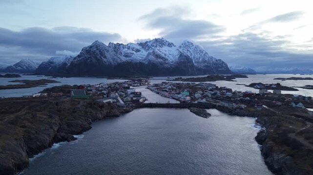Views of a coastal town in Norway with mountains and water during twilight hours
