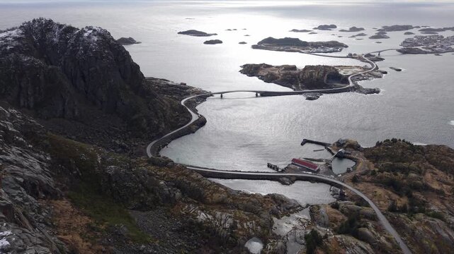 Exploring the winding road through islands on a clear day in Norway