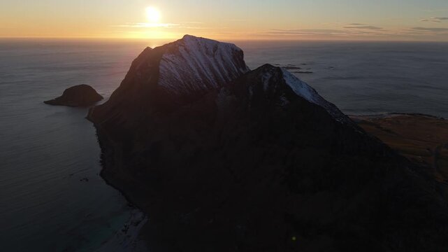 Sunrise over mountain and sea with changing sky colors in Norway