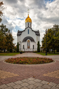 White church with golden dome stands serene