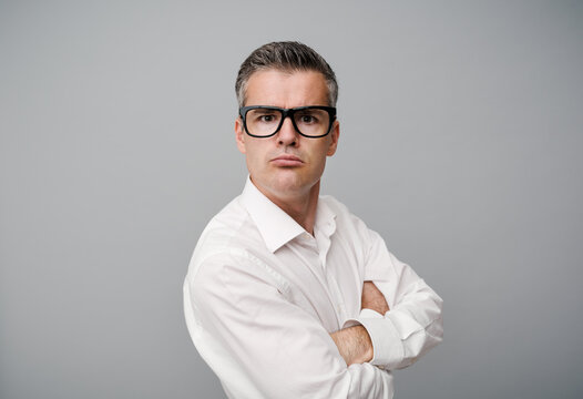 Arrogant snobbish man posing with arms crossed