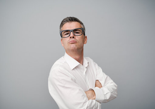 Arrogant snobbish man posing with arms crossed