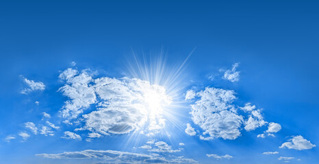 Bright rays shining sun at center of composition formed large group cumulus clouds. Empty copy space at the top is suitable for inscriptions. A wonderful summer day for the beginning of great events. © codexserafinius