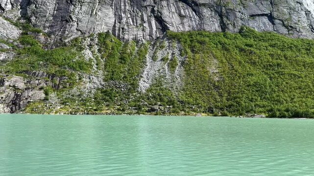 Turquoise lake among the rocks Briksdalsbreen
