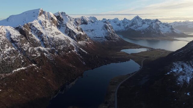 Mountain view with lakes and snow in Norway during sunset near the sea