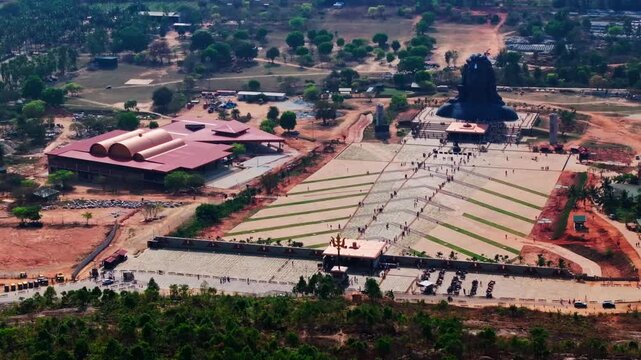 Suryakunda with Shri Navagraha Devara Temple, Adiyogi Shiva Statue and Shri Mahashula (Trishula) at Isha Foundation Chikkaballapura, karnataka, india. day time, semi orbit shot, drone shot, 4k.