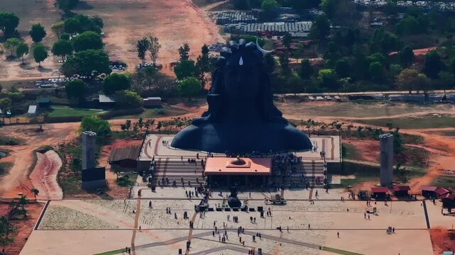 Close up shot of Adiyogi Shiva statue with Yogeshwara Linga Gudi, Nandeeshwara statue and tourist at Isha Foundation, Chikkaballapura, karnataka, india. day time, stable shot, drone shot, 4k.