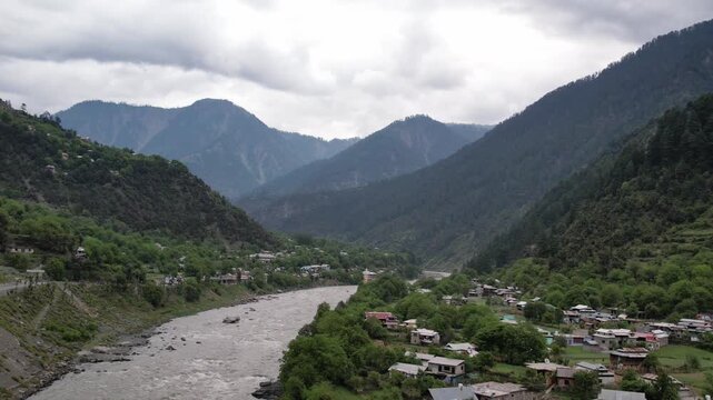 Neelum River flows through Athmuqam and Parli Village beneath mountains in Neelum Valley, Pakistan