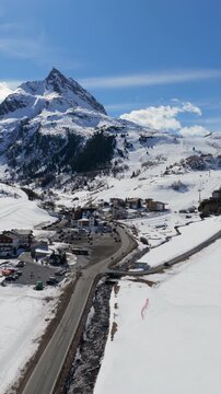 Village Of Wirl In Austria's Paznaun Valley In Silvretta Mountain Range. vertical, aerial sideways shot