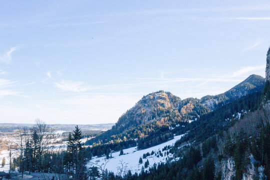 Mountain hill landscape with forest and blue winter sky in Bavaria, scenic outdoor panorama, peaceful countryside destination, travel and nature concept.
