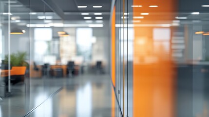Fototapeta premium A blurred view of a modern office interior with orange accents and glass walls