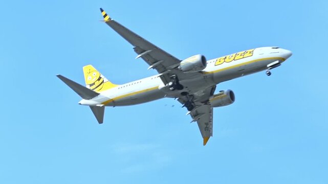 A passenger plane gracefully soaring through the sky, seen from below and from the side. Commercial flights through a travel agency. Flight reductions and cancellations, energy crisis, tourist season.