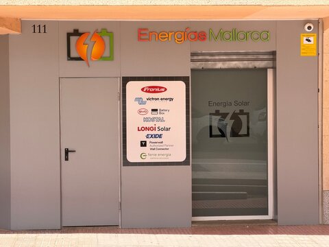 Palma, Spain - May 07, 2026: Energias Mallorca storefront featuring solar energy solutions, visible brands including Victron Energy and Exide, located in a modern urban setting