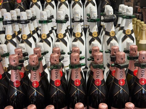 Calvia, Spain - May 05, 2026: Bottles of champagne stacked in a display, featuring Moet & Chandon and other brands, showcasing various colors and designs