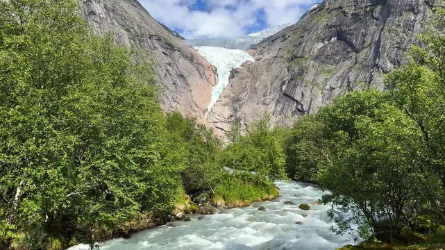 The raging river behind the view of the Briksdalsbreen glacier
