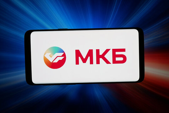 Stuttgart, Germany - 05-08-2026: In this photo illustration, the logo of financial company Credit Bank of Moscow (MKB) is displayed on a smartphone in front of abstract background on computer screen.