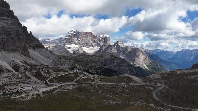 Dramatic clouds casting shadows over dolomite mountains