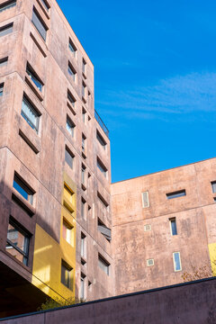 Pink walls and small balconies lift a Paris Rive Gauche apartment facade inside modern residential architecture and compact urban housing