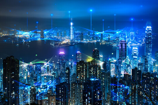 Futuristic smart city cityscape with visual digital data connection technology icons at night.