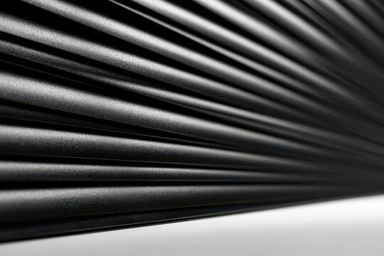 Close-up abstract texture of parallel black ribbed lines with a subtle grainy surface and soft lighting.
