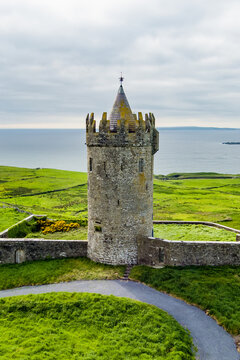 Aerial view of Doonagore Castle near Doolin, County Clare, Ireland. Historic Irish tower house overlooking the Atlantic coast on the Wild Atlantic Way.