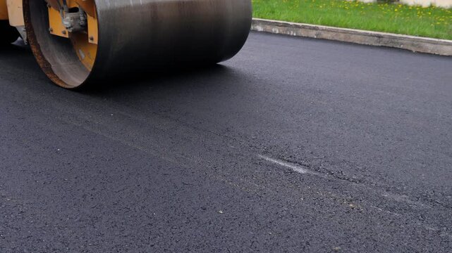 Road Roller Compacting Fresh Asphalt During Active Road Construction