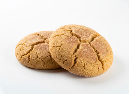 Freshly baked snickerdoodle cookie with cinnamon and sugar sprinkle. Traditional round biscuit isolated on white background. Homemade pastry dessert for coffee break and holiday tea time.