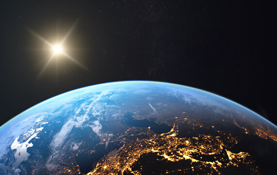 View from space of sunrise over planet Earth with glowing atmosphere, clouds and sunlight on the horizon.  Elements of this image furnished by NASA.