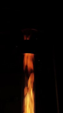 Slow Motion Fire Burning Inside a Vertical Glass Tube in Dark Environment Cinematic Footage