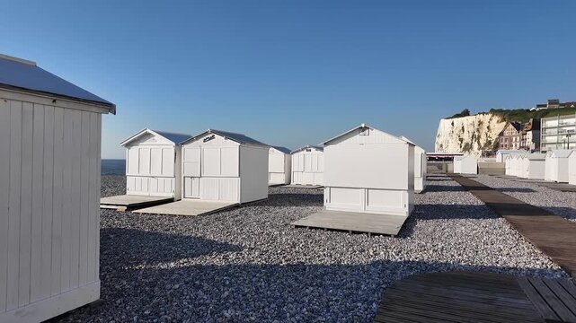Moving view of beach huts and cliffs in Mers-les-Bains, normandy coast 
