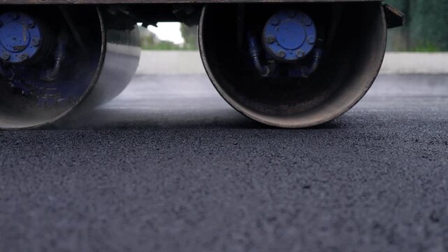 Road Roller Compacting Fresh Hot Asphalt With Rising Steam