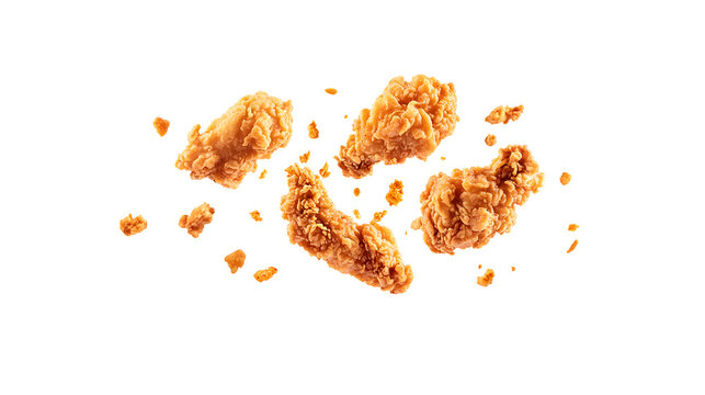 Fried chicken wings flying through air with crumbs