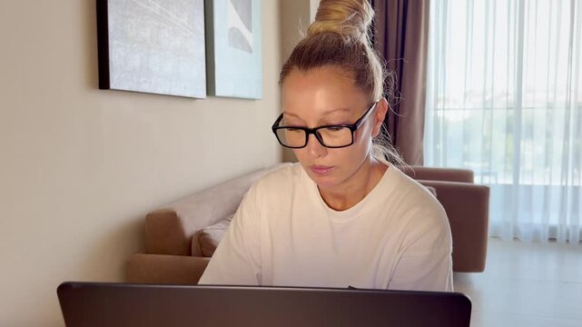 a young woman working on a laptop from home