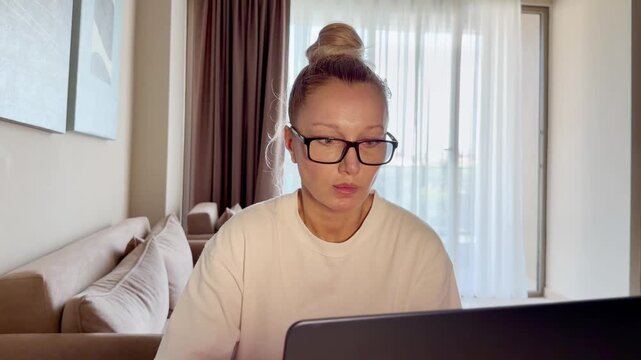 a young woman working on a laptop from home