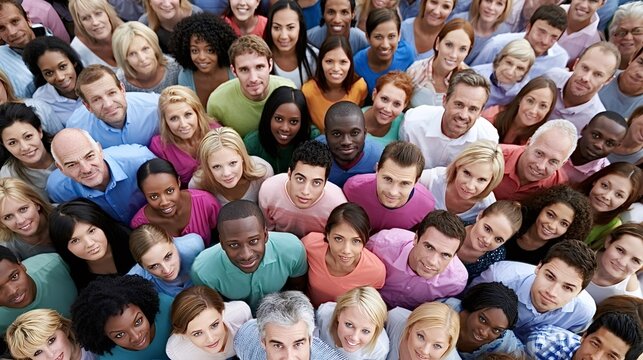 Diverse group of people from various ethnicities smiling at the viewer, symbolizing community, unity, and a global population from an overhead high angle perspective