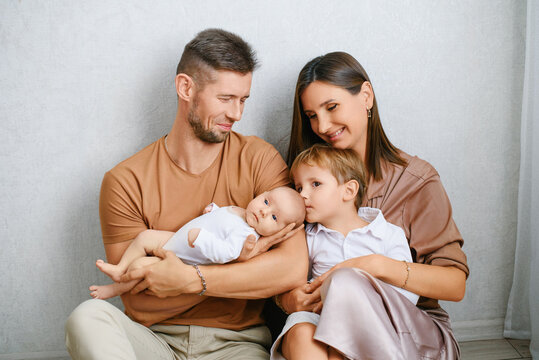 Happy Parents With Baby And Older Son