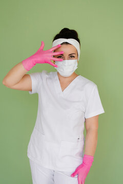 Female Physician Placing Hand in Pink Glove