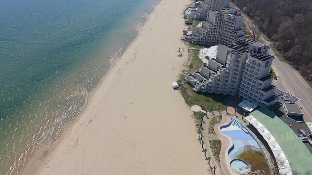 Beautiful coastline aerial view with sandy shore turquoise ocean and distant coastal landscape scenery nearby
