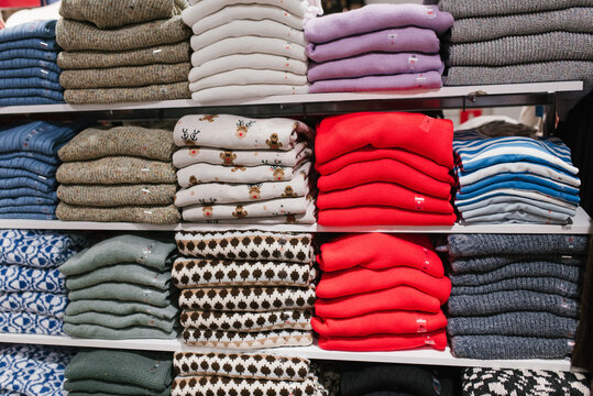 Wall Display of Neatly Folded Knitwear and Winter Sweaters