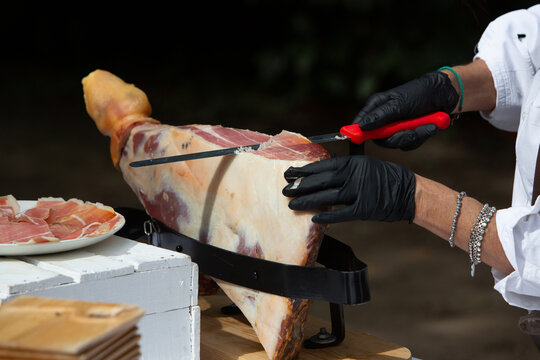 Chef slicing iberian ham for gourmet food service
