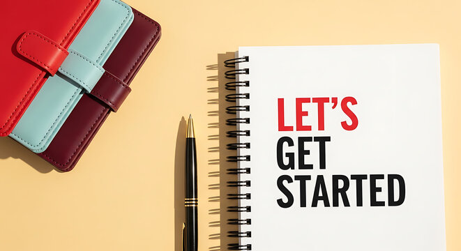 A spiral notebook with a pen and a leather journal on a yellow background with the words lets get started