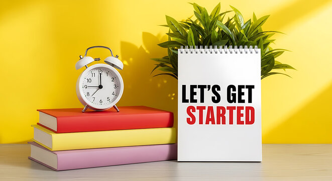 Lets get started text on notebook with books clock and plant on yellow background