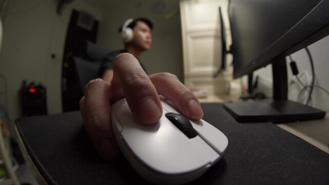 Asian man gaming moving mouse. Close up with fisheye lens