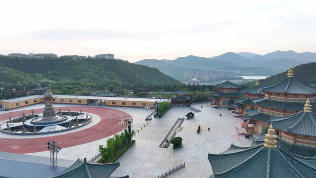 Panoramic view of the Guanyin Dharma Realm complex on Mount Putuo in Zhejiang with traditional Chinese temple architecture and mountain backdrop