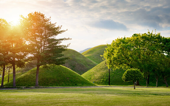 Landscape of the ancient Silla Dynasty royal burial mounds (tumuli) in Daereungwon Tomb Park at Sunset, Gyeongju, South Korea.