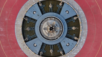 Naklejka premium Top-down view of a circular hydroelectric turbine with detailed mechanical structure and metallic components