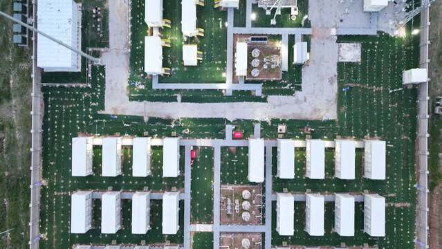 Aerial view of a large temporary modular building complex with organized green landscaping and infrastructure layout