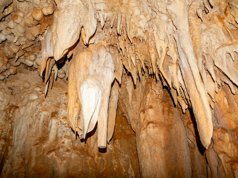 Exploring flowstone and cave formations in Sakalavas cave located in limestone of Anjajavy Private Reserve, Madagascar