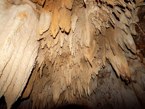 Exploring flowstone and cave formations in Sakalavas cave in Madagascar's limestone landscape