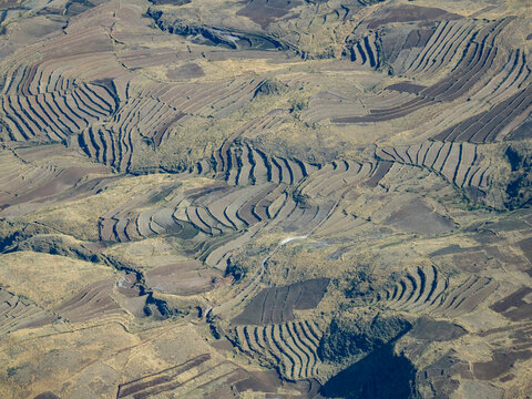 Charter flight view over terraced farmlands in Madagascar during journey to Antanavarino Charter Flight Base